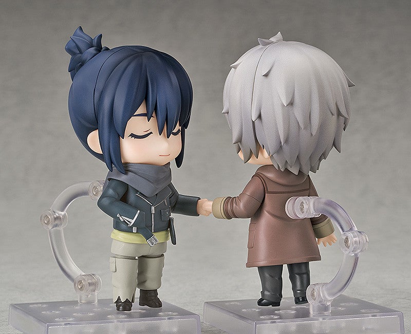 Two Nendoroid figures one with dark blue hair and a grey scarf the other with spiky grey hair and a brown coat