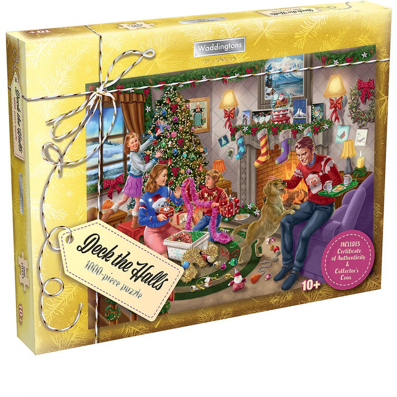 A gold puzzle box shows a family and dog decorating a Christmas living room with a tree and fireplace