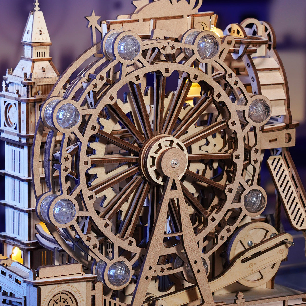 Detailed wooden mechanical model of a Ferris wheel and clock tower, showing gears and illuminated cabins