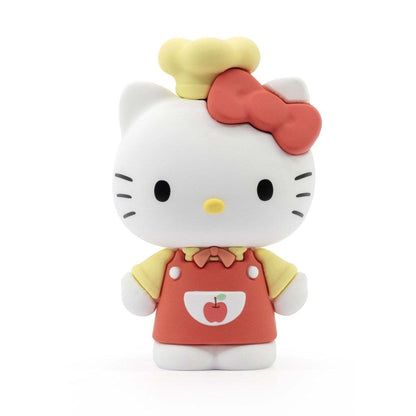 Hello Kitty figure wearing a red bow, yellow chef hat, and a red apron with an apple logo