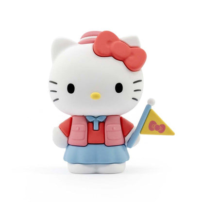 Hello Kitty figurine in scout attire holding a yellow flag