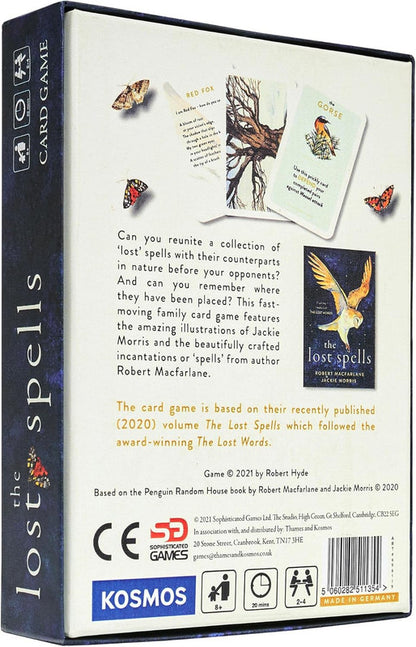 Components of The Lost Spells Card Game spread out cards, tokens, and rulebook visible