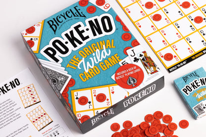 Bicycle PO-KE-NO card game box open, showing playing cards, red chips, and game boards. An unopened game box is nearby