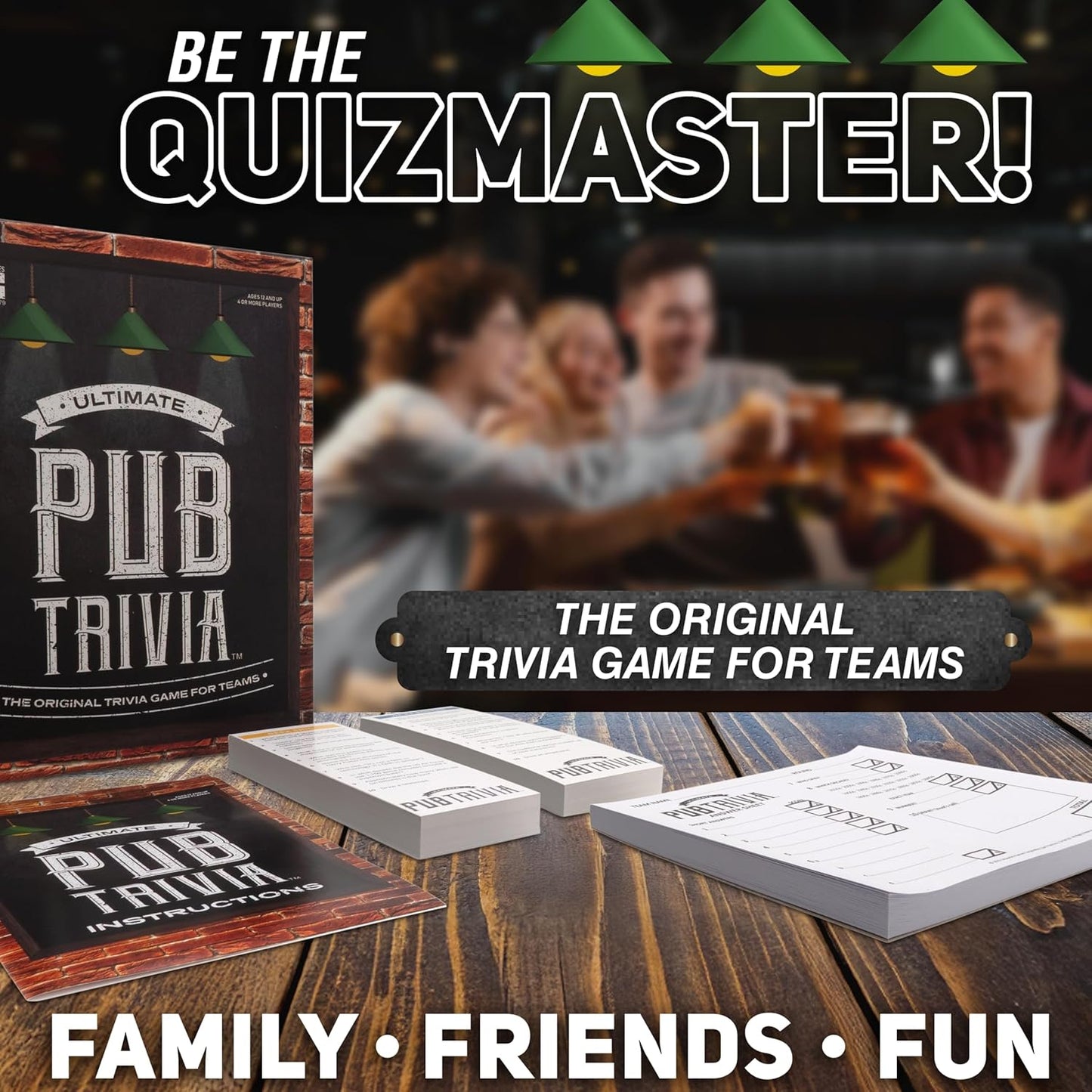 Ultimate Pub Trivia game box, cards and answer sheets on a table. Blurred people toast in a pub background