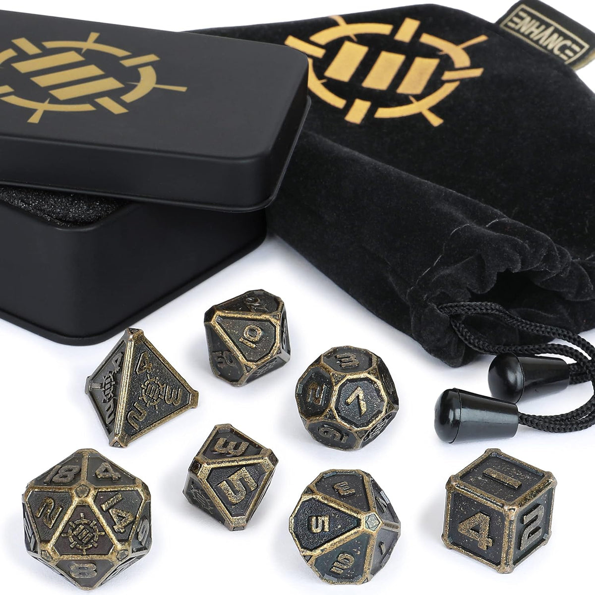 A set of antique bronze metal dice scattered on white, with an open black tin and velvet pouch