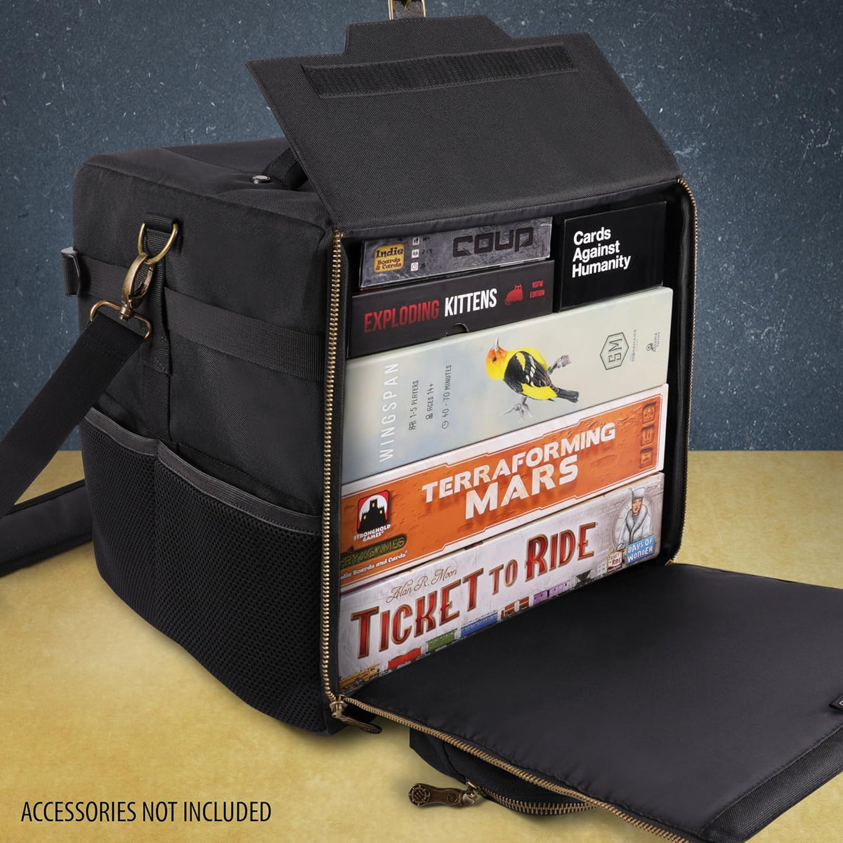 Open black board game organizer bag, packed with games including Wingspan and Ticket to Ride, on a table.