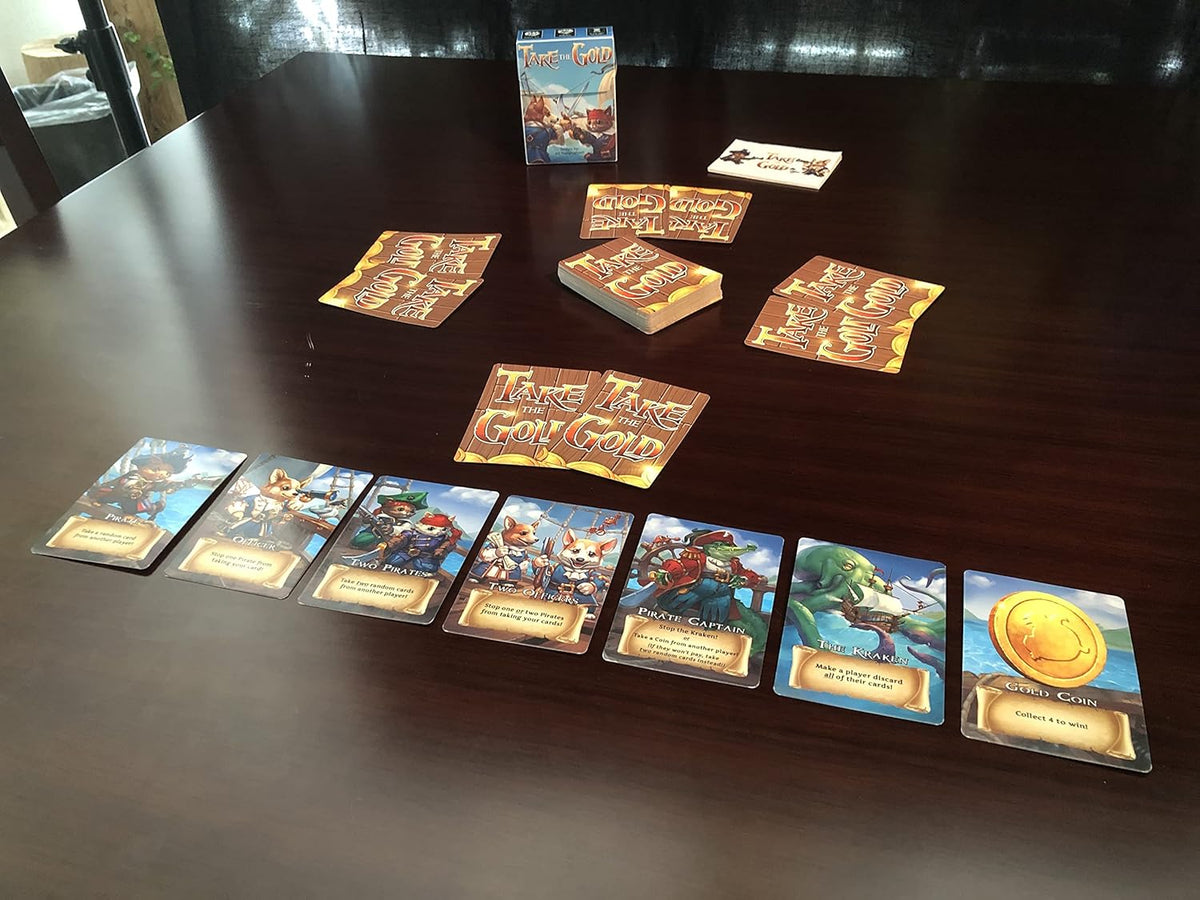 A pirate-themed &quot;Take the Gold&quot; card game laid out on a dark table, showing character and gold coin cards.