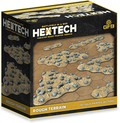 HEXTECH 'Battlefield in a Box: Rough Terrain' product box, showing tan rocky game pieces with grey stones on a hex grid.