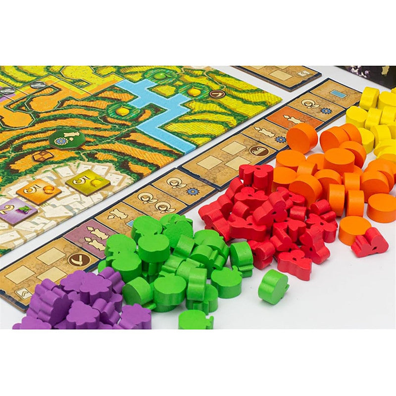 Alpujarras board game components, including a map board, score tracks, and piles of wooden meeples and tokens