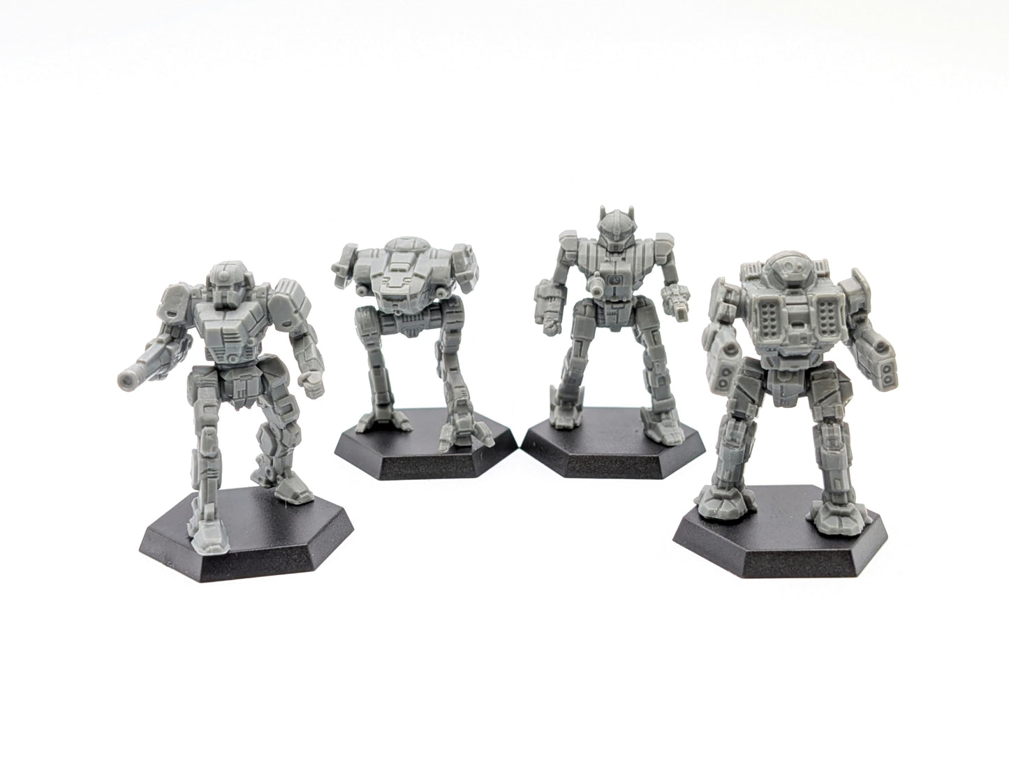 Four grey Battletech Inner Sphere Pursuit Lance mech miniatures stand on black hexagonal bases