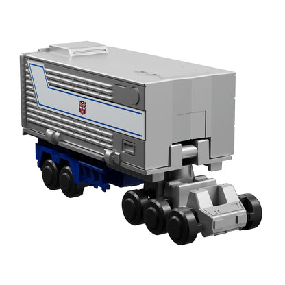The gray and blue Autobot semi-trailer toy features a prominent red Autobot insignia centered on a white and blue striped side panel