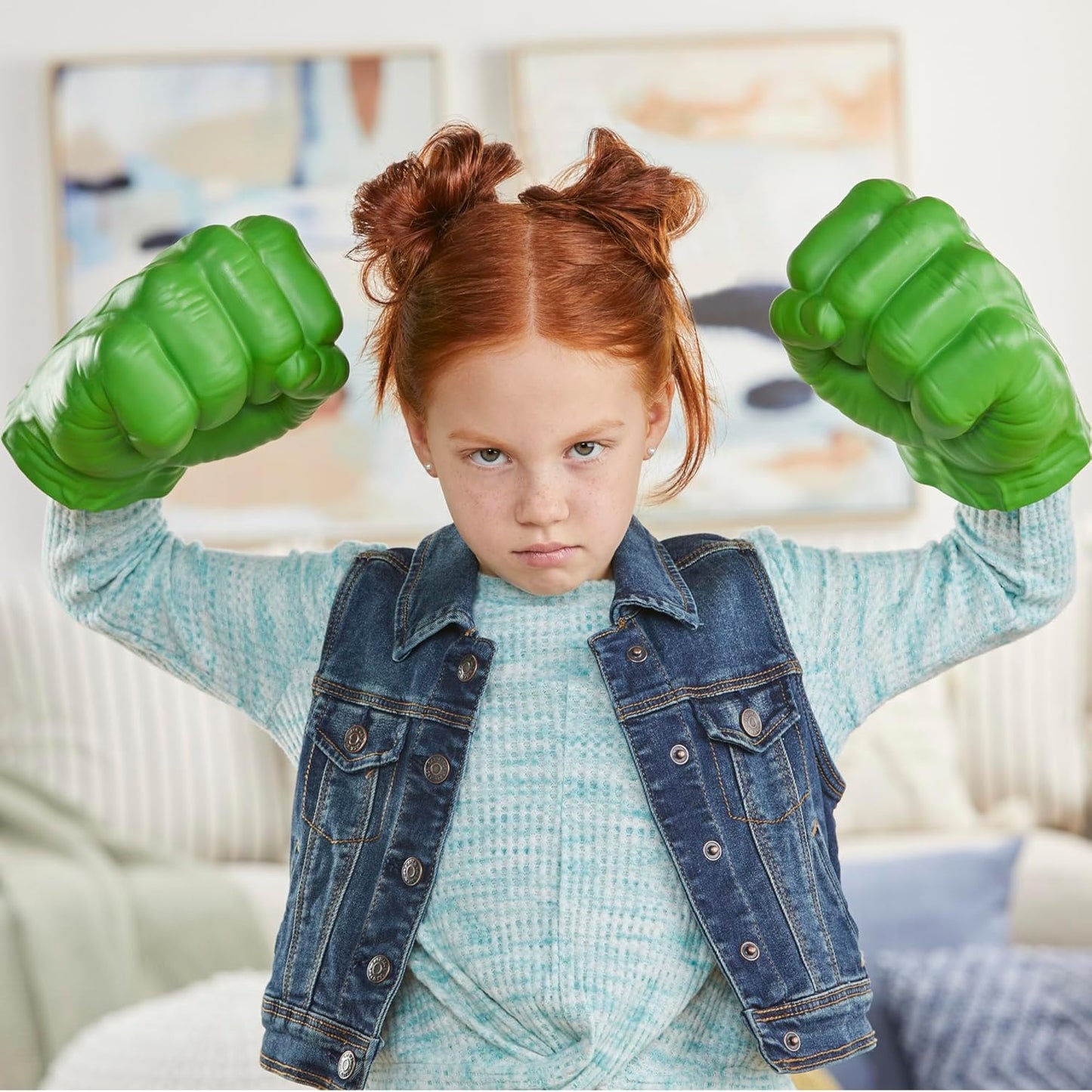 Red-haired girl in denim vest flexing huge green Hulk fists with a determined look