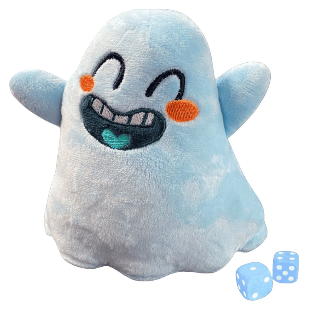 A smiling light blue Vagrantsong Ghost plush featuring embroidered black eyes, orange cheeks, and a wide laughing mouth with a teal heart detail, displayed next to two matching blue dice