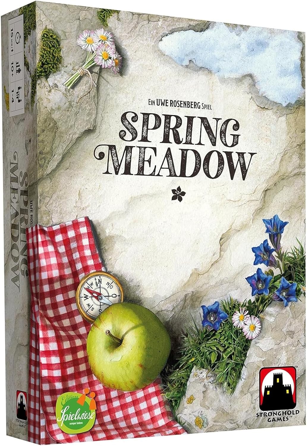 Spring Meadow board game box. Cover shows a rocky meadow with flowers, a green apple and a compass on a red checkered cloth
