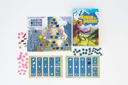Nanga Parbat board game laid out: box, mountain-themed board with colourful tiles, player boards, and various wooden tokens on white