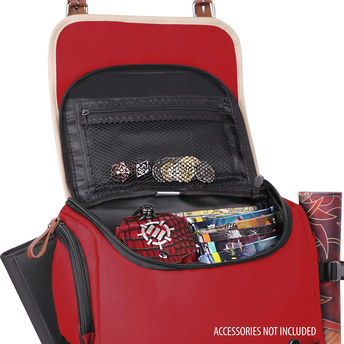 Open red gaming backpack with dice, coins, and game booklets visible in compartments, a rolled mat is strapped to the side.