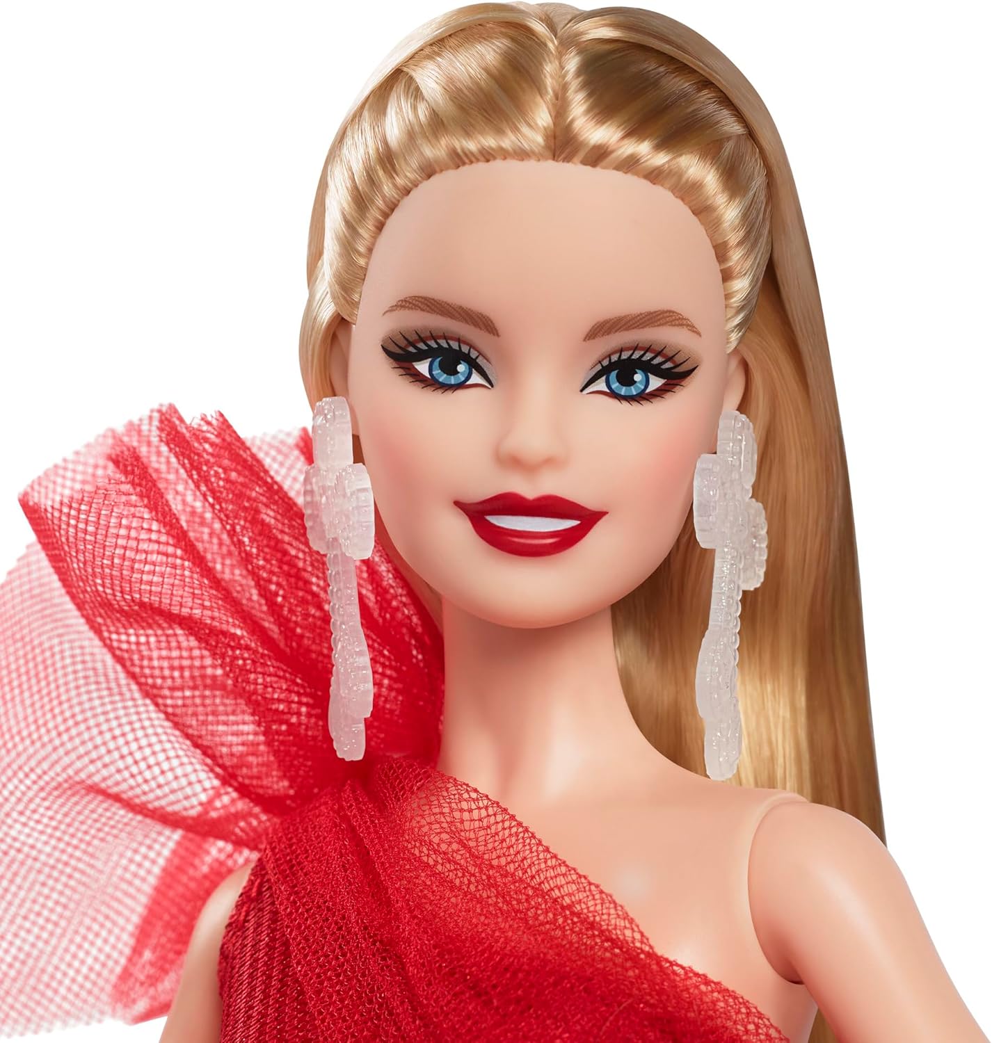 A smiling blonde Barbie doll in a red off-shoulder gown with a ruffled shoulder and clear dangle earrings