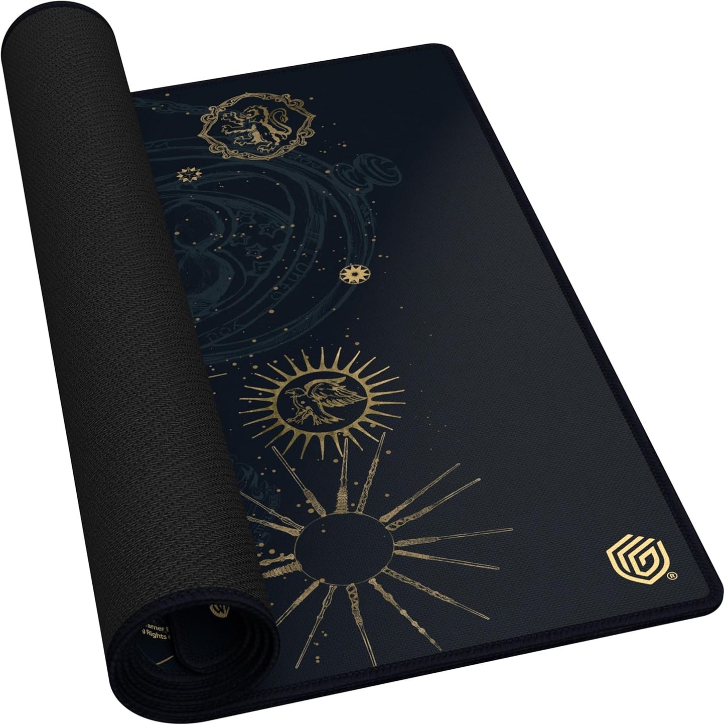 Partially rolled dark desk mat, displaying gold celestial graphics and black textured rubber backing
