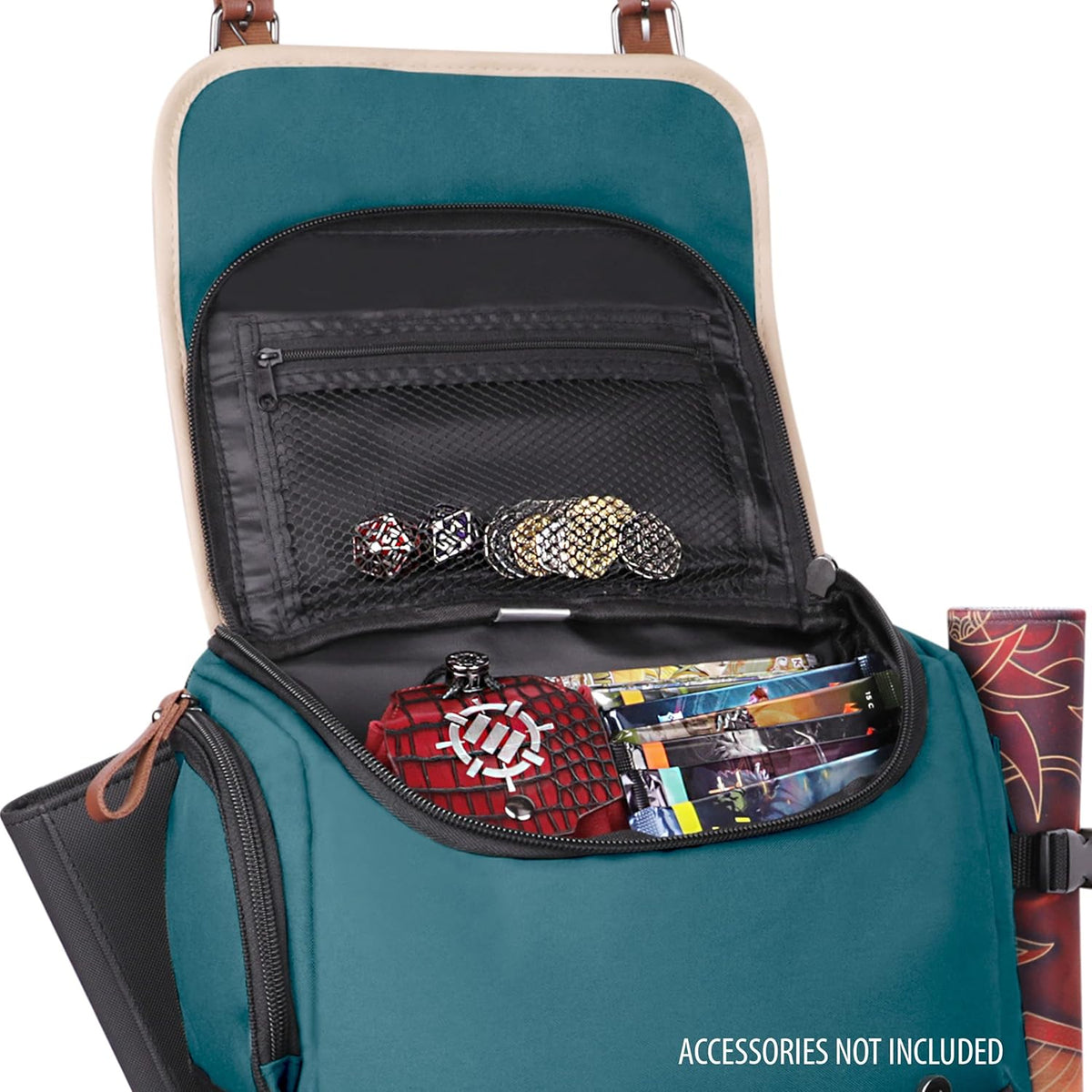 Open teal backpack filled with gaming items: dice, coins, game cards, and a red case. A rolled mat is secured to the side.