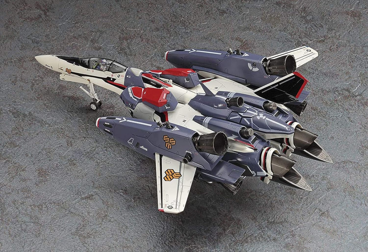 Detailed sci-fi variable fighter jet model kit, painted white, slate blue, and red, resting on landing gear