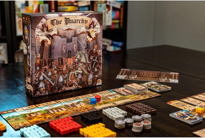 Board game "The Anarchy" set up, showing the box art, game board track, and multicolored wooden tokens