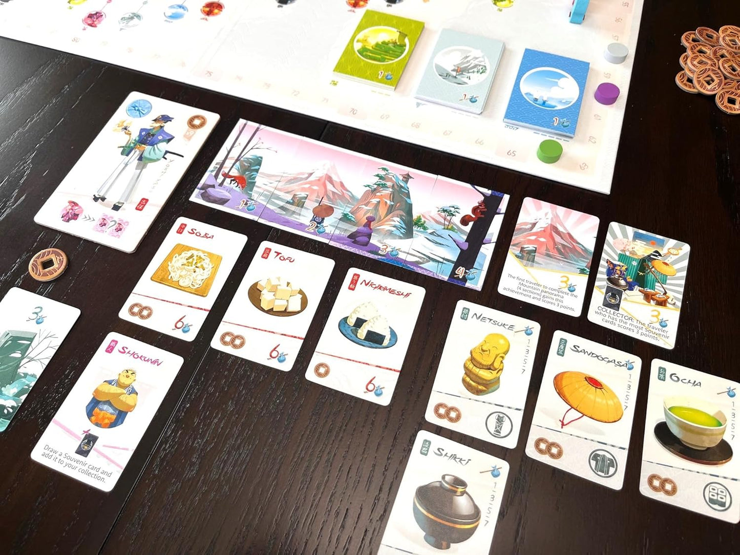 Tokaido board game cards (Soba, Tofu, Ocha) and board section laid out on a dark table