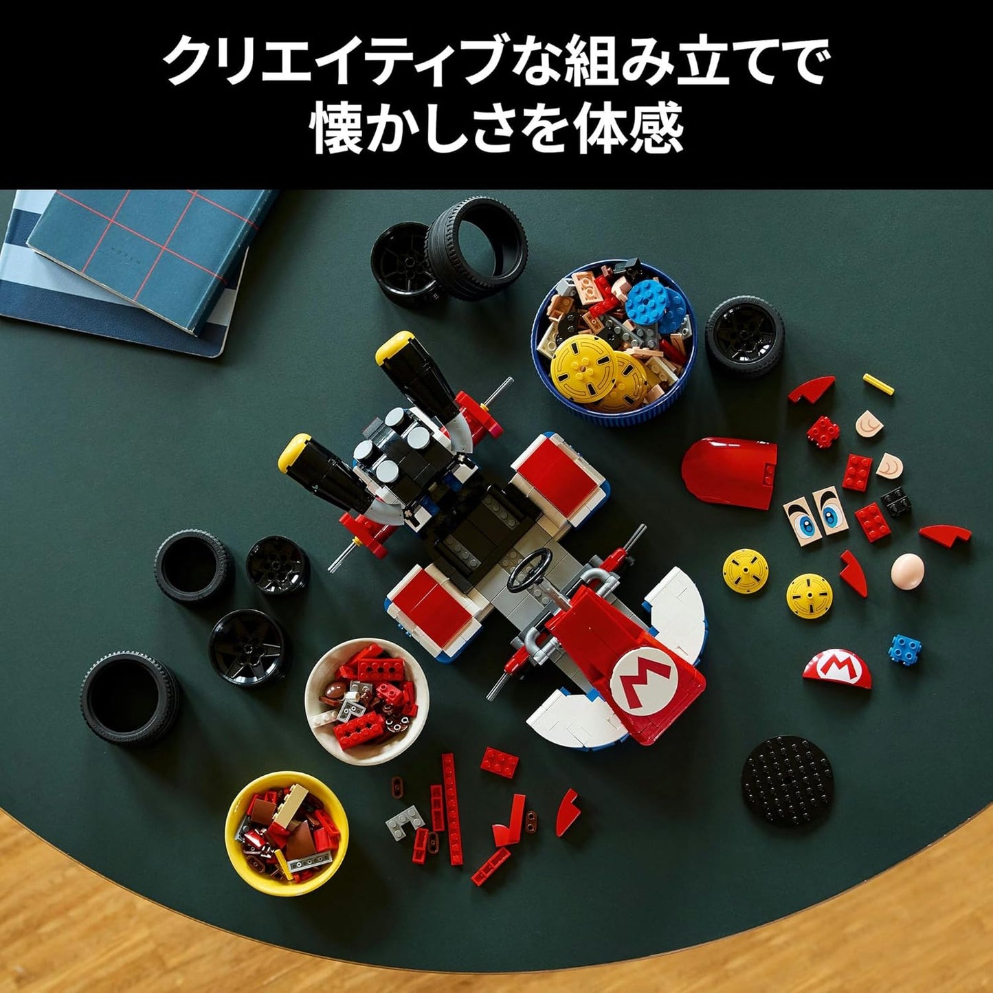 Partially built red Mario Kart made of plastic bricks, surrounded by spare parts, tires, and component bowls