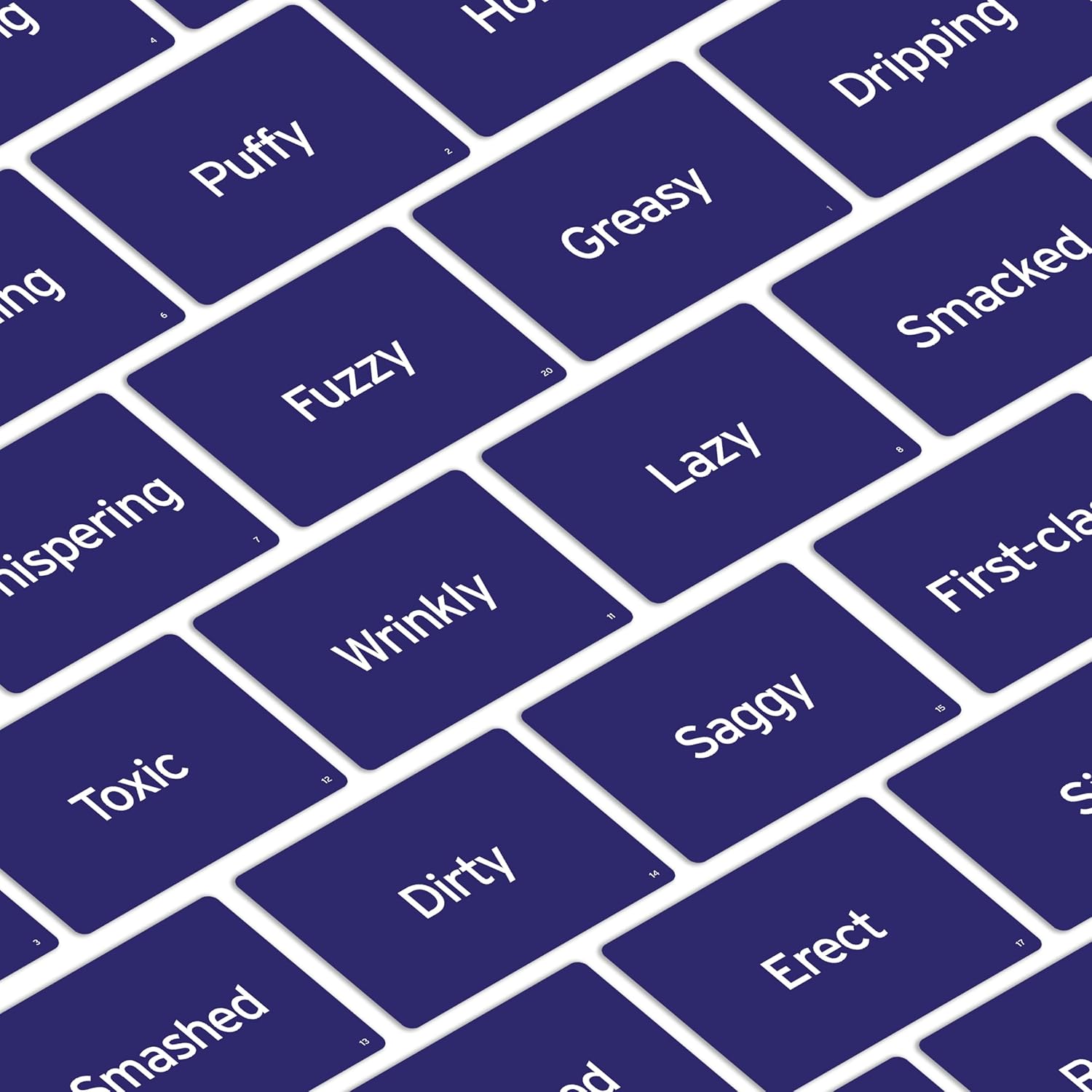 Scattered dark blue game cards showing words like "Puffy," "Greasy," "Lazy," "Wrinkly," and "Saggy"