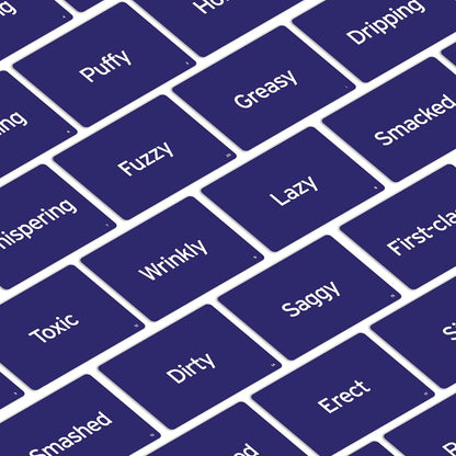 Scattered dark blue game cards showing words like "Puffy," "Greasy," "Lazy," "Wrinkly," and "Saggy"