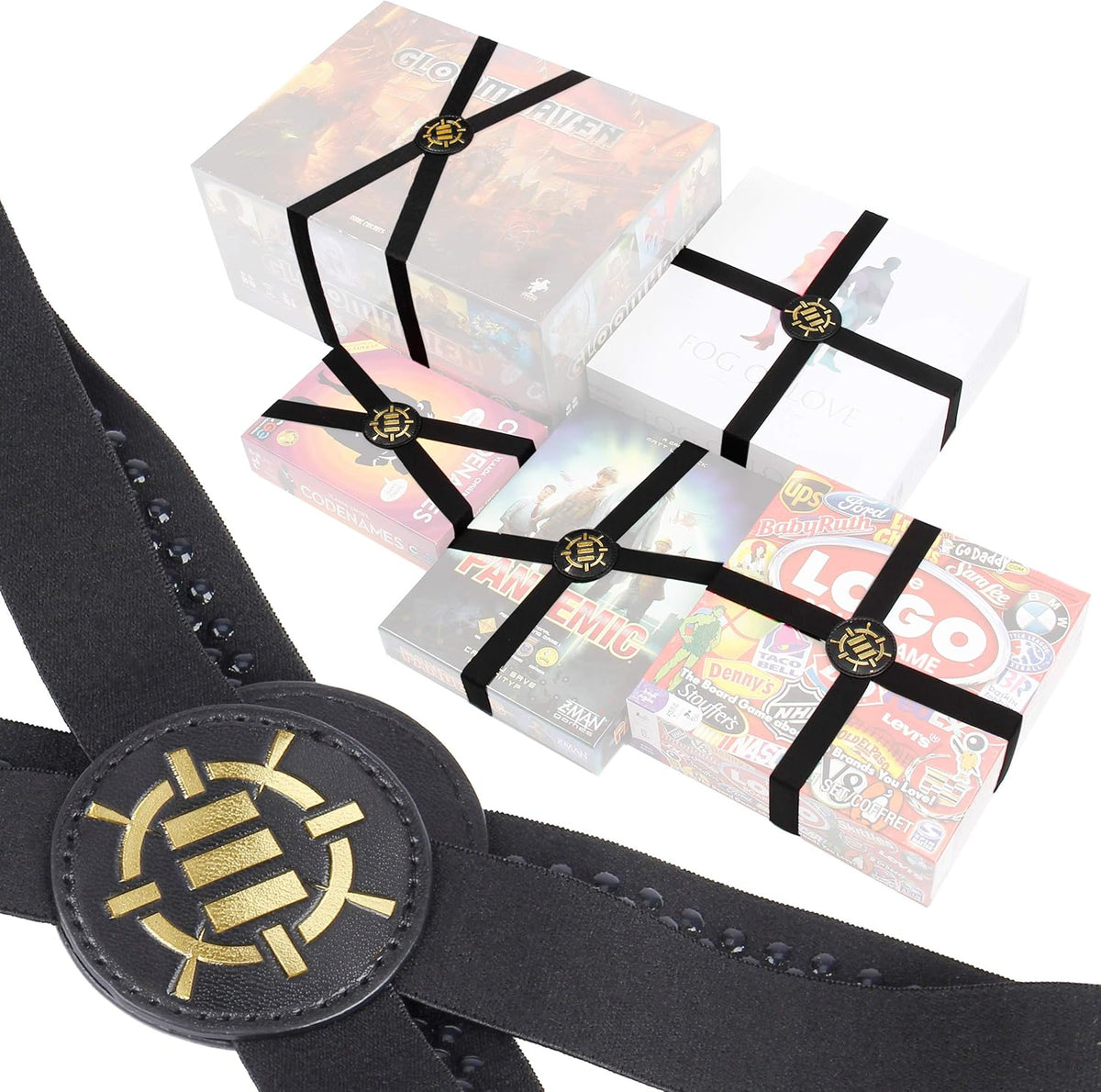 Various board games are secured with black elastic bands featuring prominent gold and black logo buckles