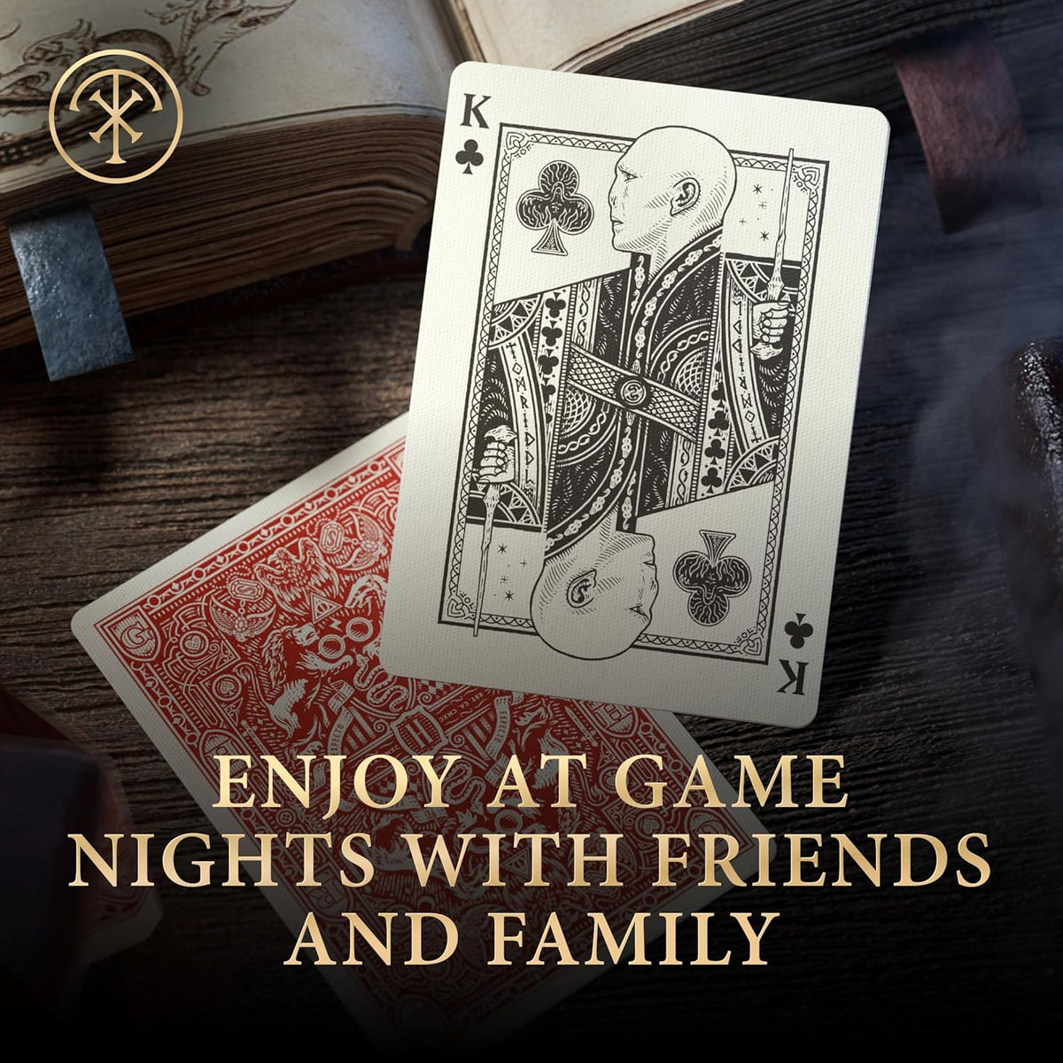 A custom King of Clubs playing card featuring a bald character holding a wand, on a red card and wooden surface