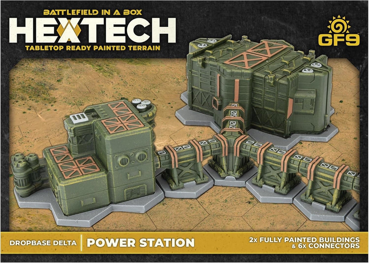 Painted Hextech power station tabletop terrain: two green modular buildings connected by conduits on a desert hex grid.