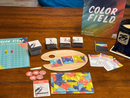 Color Field board game spread on a wooden table with game components tokens and rule cards