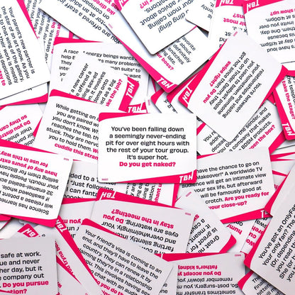 Scatter of white and pink "TBH" party game cards containing provocative text prompts and questions