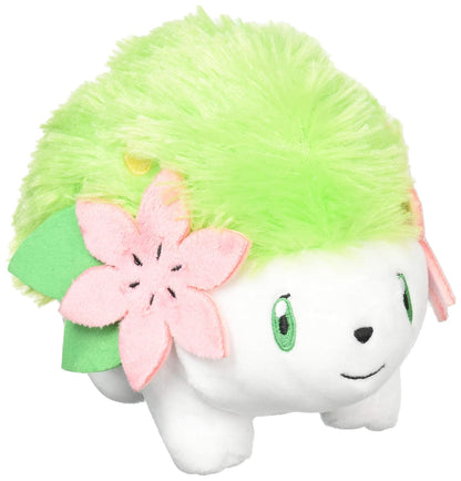 Pokémon Shaymin Land Forme plush toy, featuring a white body, fuzzy green fur, and a large pink flower on its side