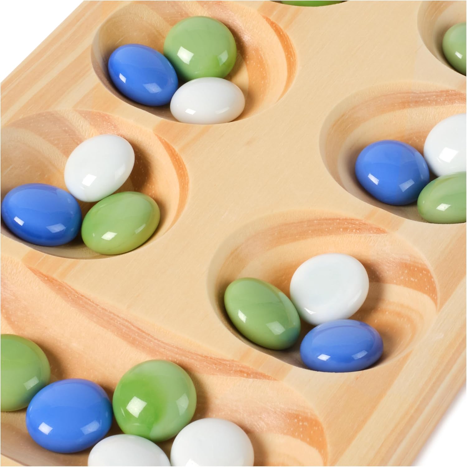 Wooden Mancala board pits filled with blue, green, and white glass marbles