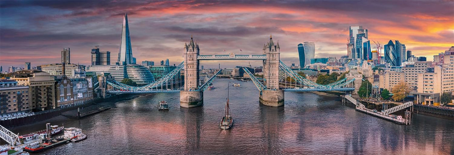 London's Tower Bridge raised over the Thames as a sailboat passes below, framed by the city skyline and sunset