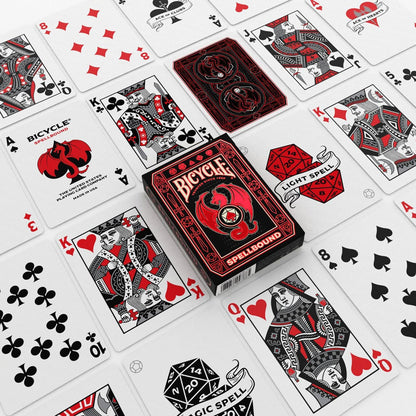 Custom red and black Bicycle Spellbound playing cards spread around the matching dragon tuck box