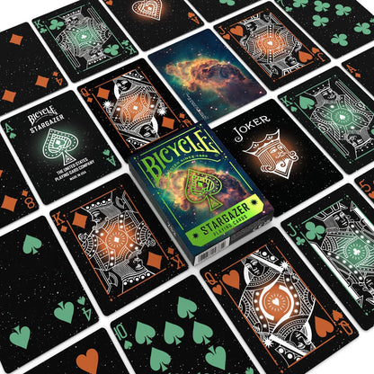 Display of Bicycle Stargazer playing cards set, featuring black cards with glowing orange and green cosmic art