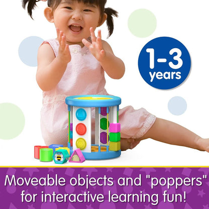 Smiling toddler playing with a vibrant, colourful sensory learning toy and geometric blocks, suitable for ages 1-3 years