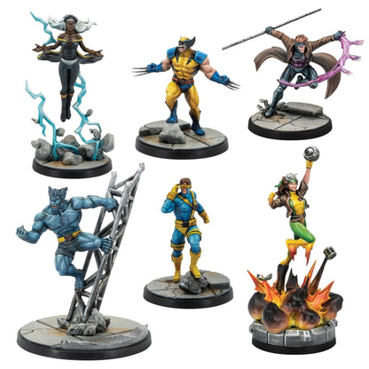 Six painted miniatures from the Marvel Crisis Protocol X-Men Starter Set show Storm Wolverine Gambit Beast Cyclops and Rogue on detailed scenic bases