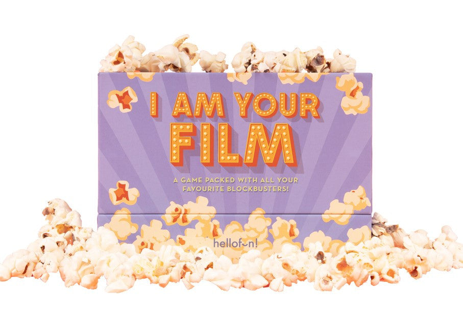 Movie-themed purple game box, "I AM YOUR FILM", surrounded by scattered popcorn.
