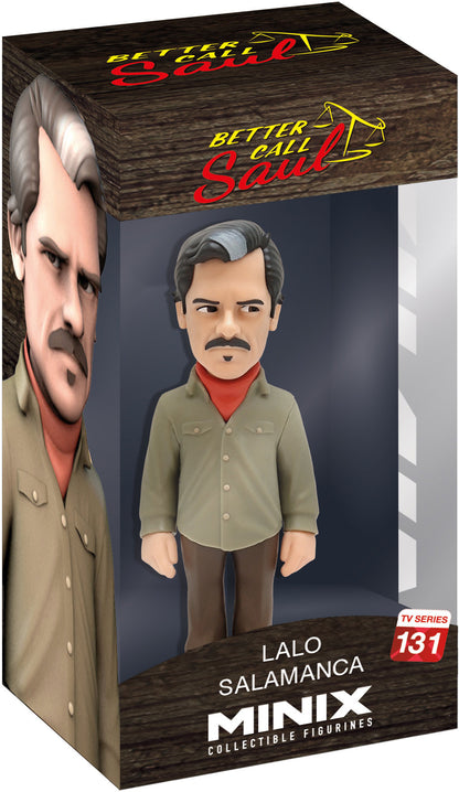Boxed vinyl figure of a male character with black hair and a white streak, khaki-green tracksuit, and relaxed arms; moustache and goatee visible through clear display window
