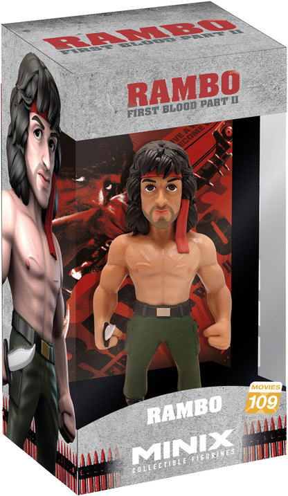 Front view of Rambo figure with red bandana, bare chest, and muscular arms holding a rifle
