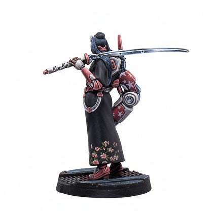 A miniature figure of a warrior from Infinity NA2 Beasthunters Free Guild with a black floral robe, red armor, and a sword across their back