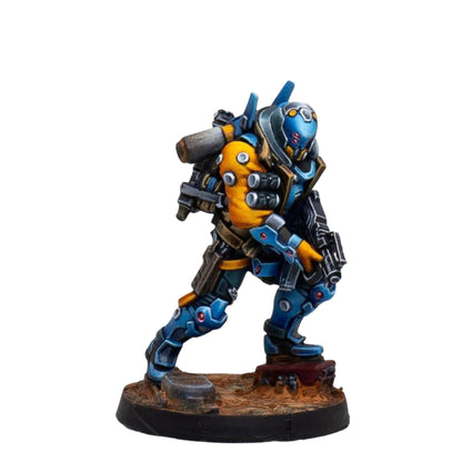 A blue and yellow armored futuristic soldier miniature from Infinity PanOceania Kestrel with a weapon and backpack standing on a terrain base