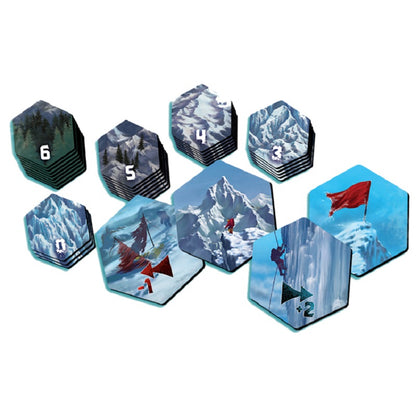 Dicey Peaks board game hexagonal tiles featuring various mountain scenes including numbered terrain 0-6 an abandoned tent a climber and a summit flag suggesting strategic gameplay