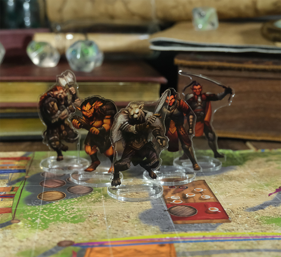 Skinny Minis evil minions token set on a board game map featuring acrylic standees of various fantasy creatures like orcs and gnolls
