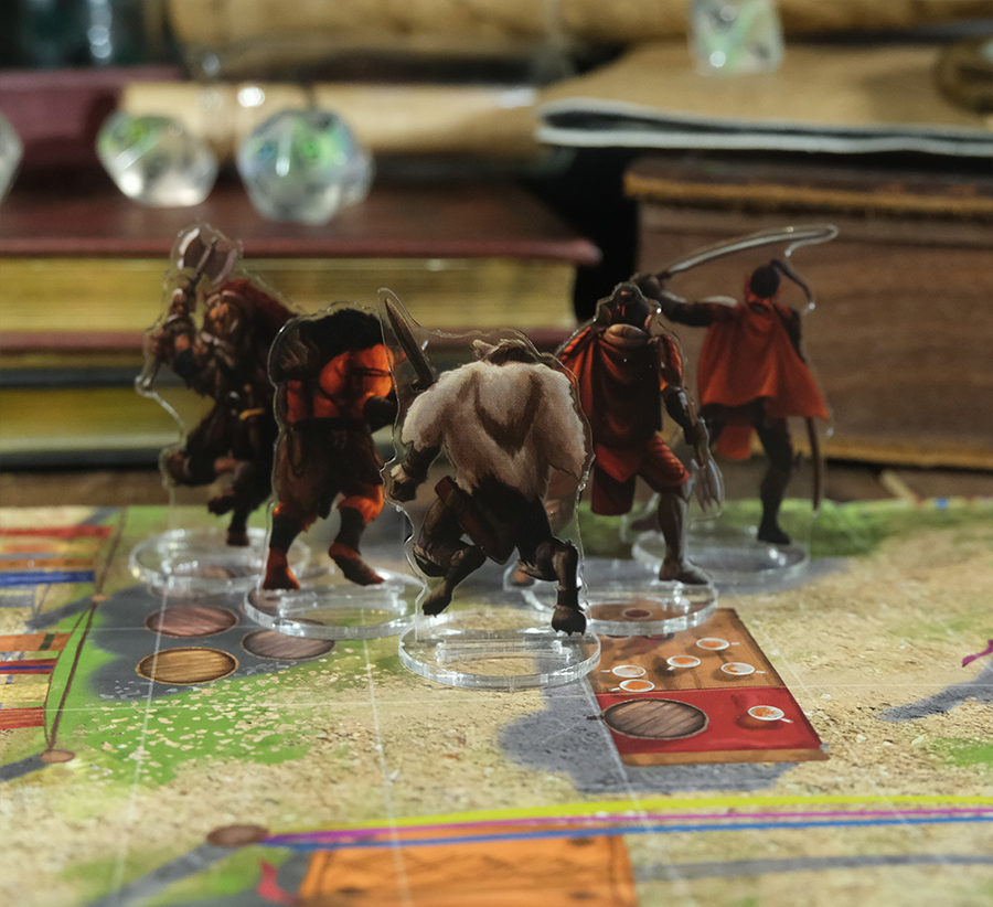 Skinny Minis Evil Minions a set of translucent acrylic tabletop RPG miniatures featuring detailed fantasy characters like orcs and warriors with weapons displayed on a game board