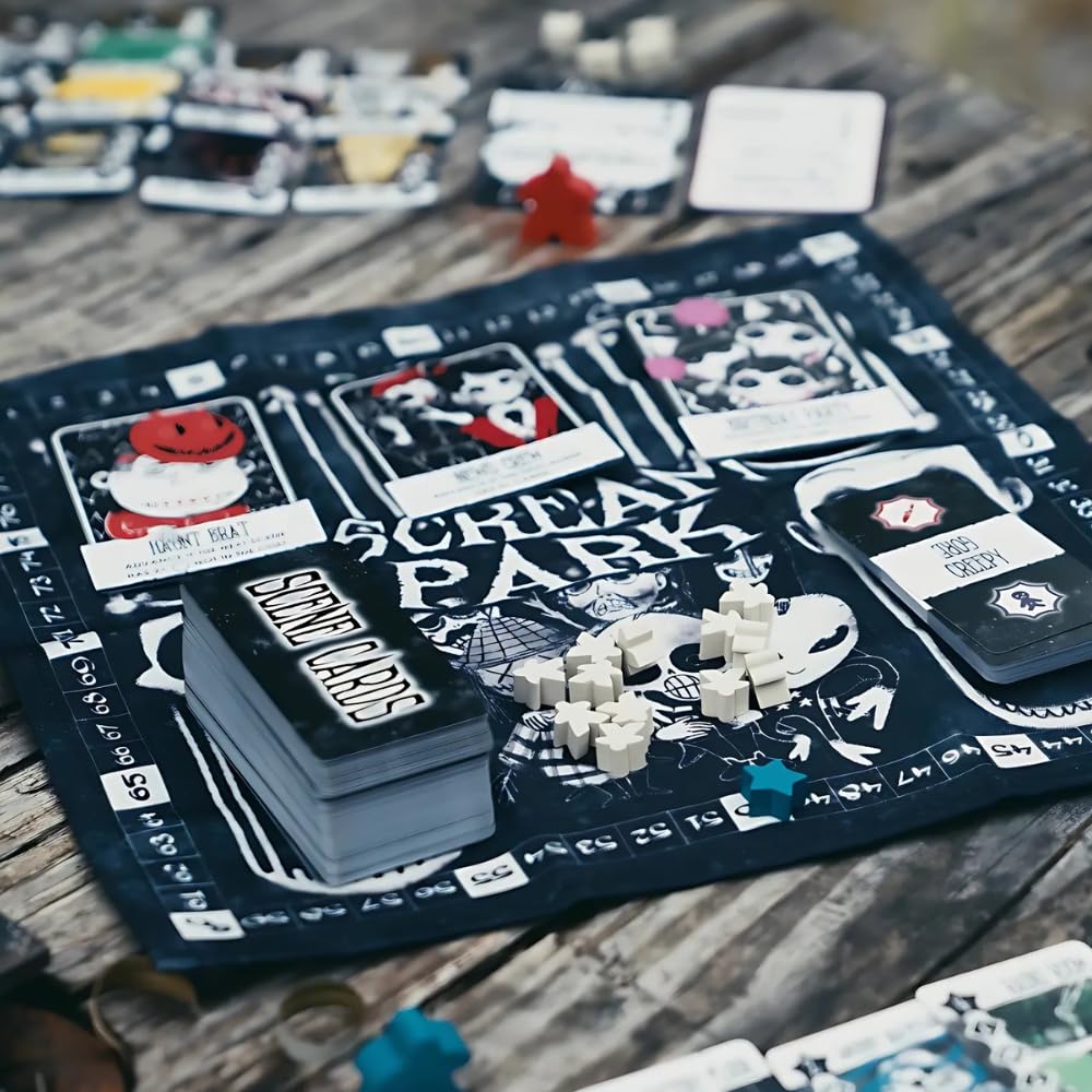 The Scream Park board game components spread on a wooden surface showing the dark mat scene cards and a pile of star-shaped white wooden tokens